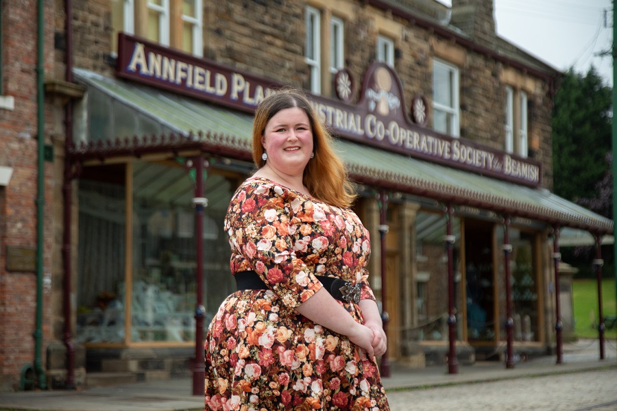 WI Member Romilly photographed in front of a store on the street