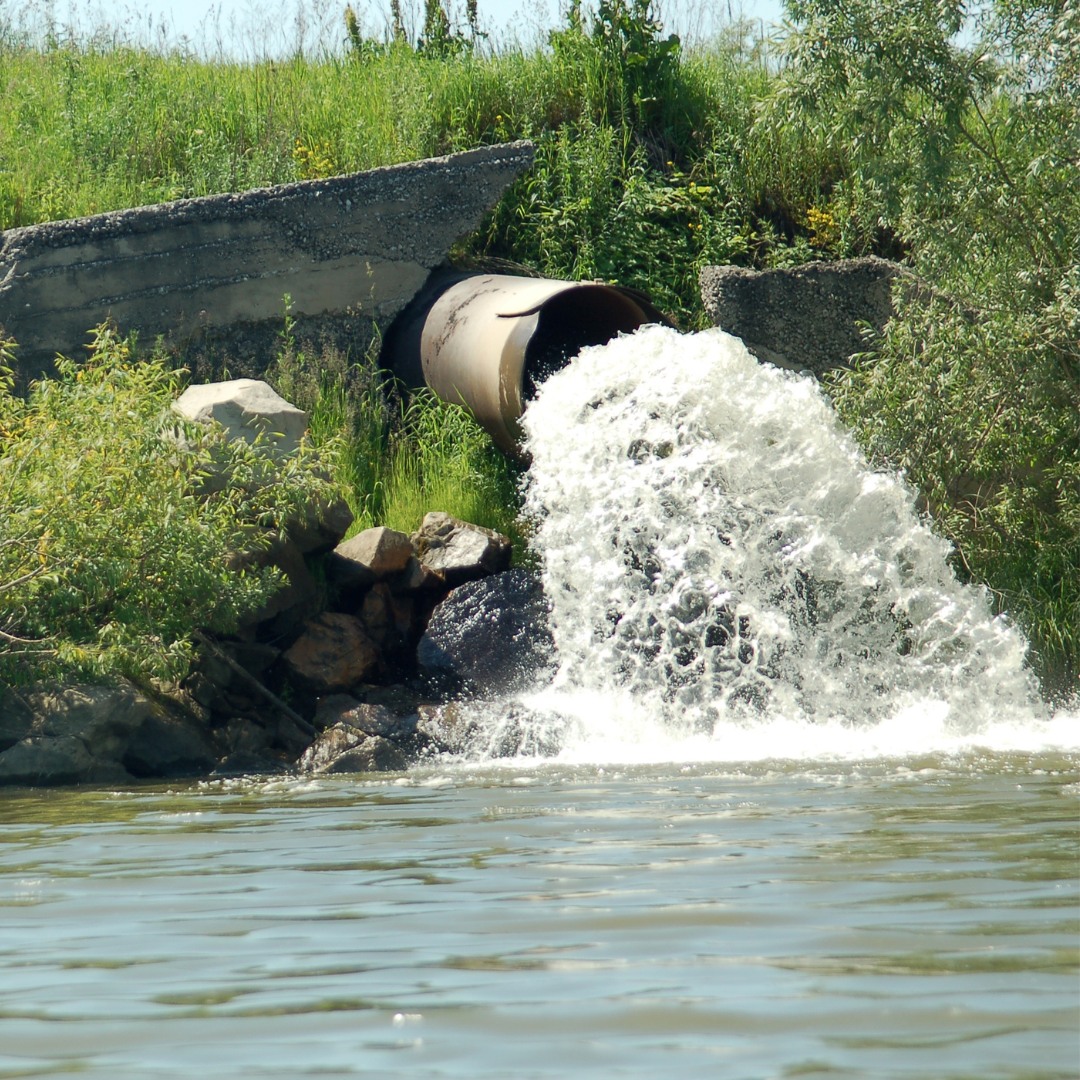 Sewage pipe discharging into to a river