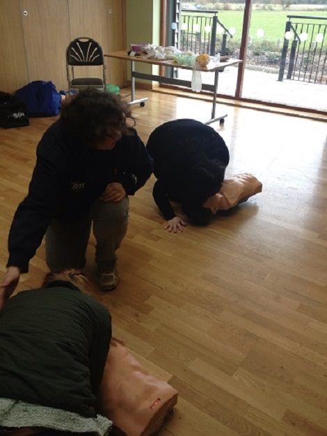 First Aid Instructor observes pupil conduct mouth-to-mouth